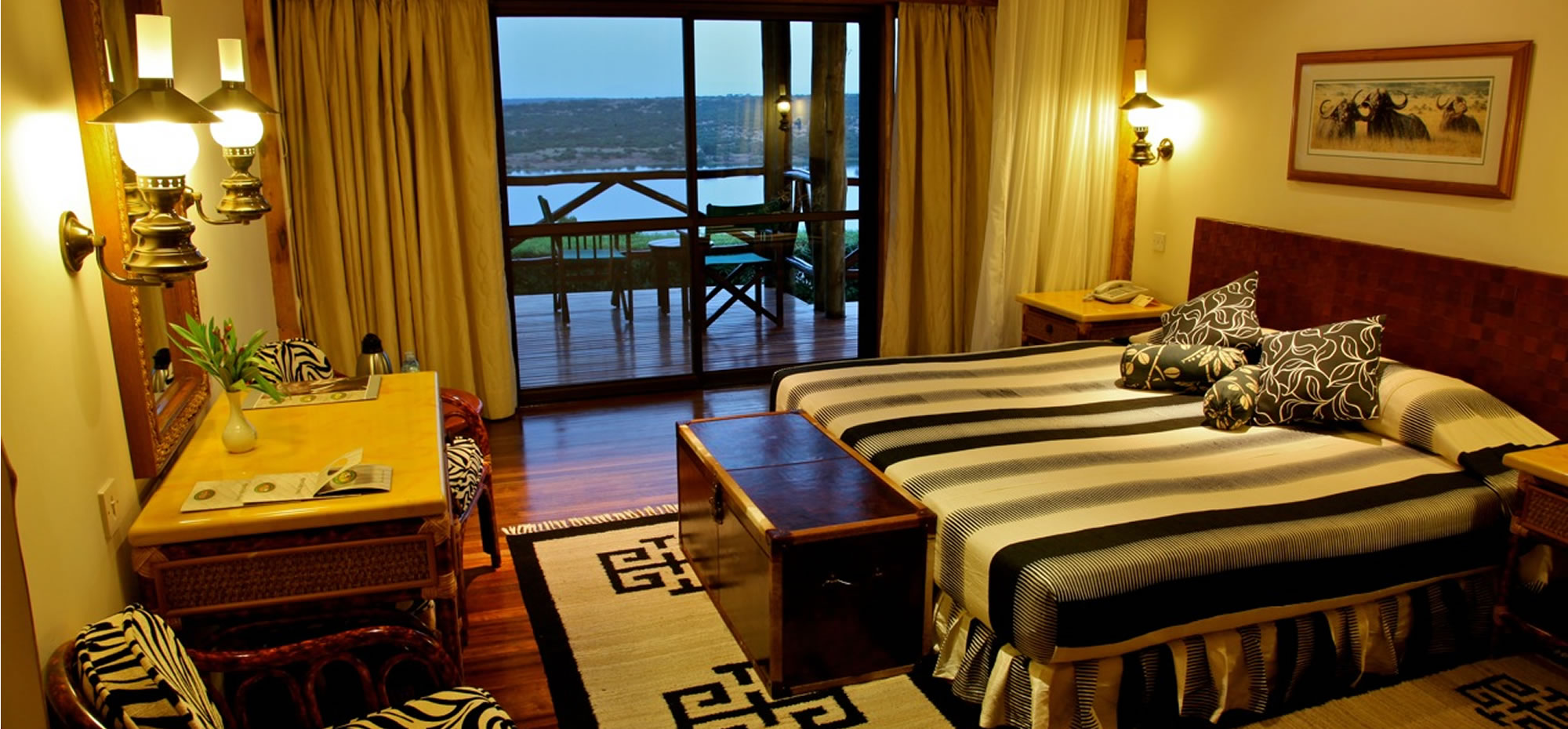 Inside safari accommodation featuring double bed and desk